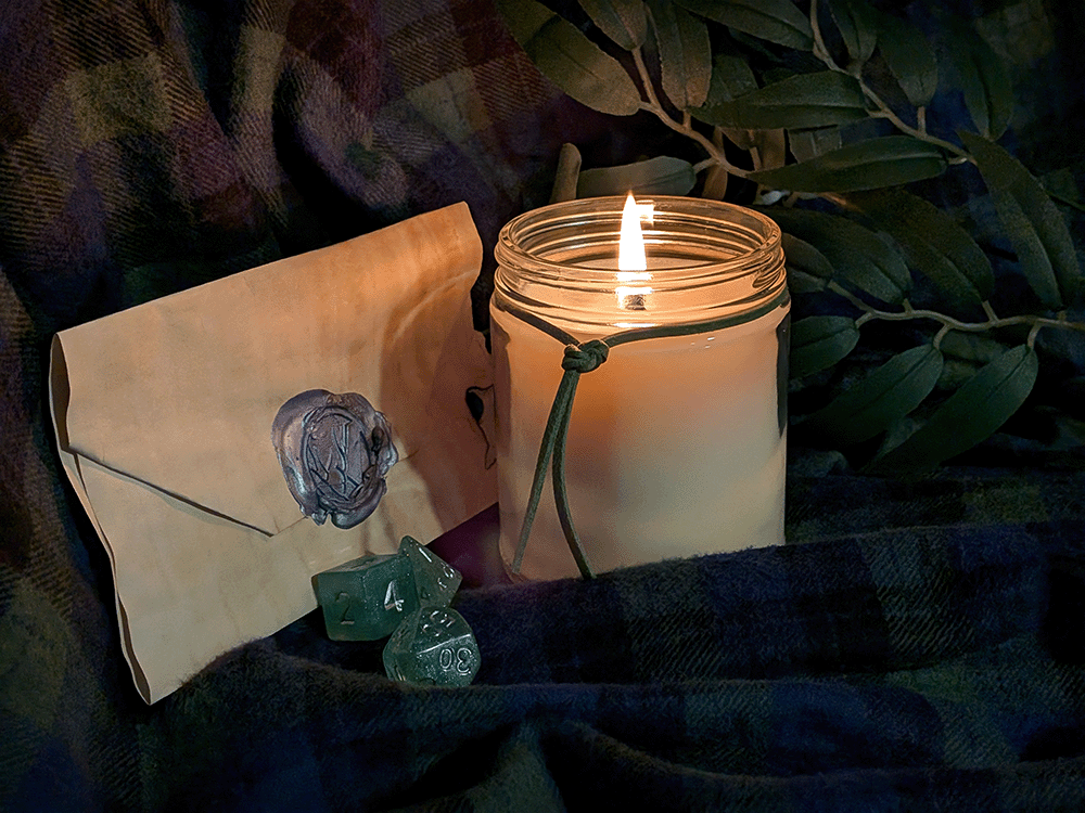 Candle with a wax-sealed envelope and green dice on a dark fabric background